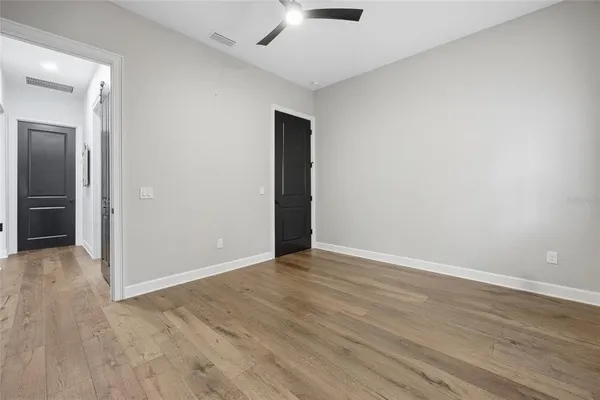 a bedroom with a bed and painting on the wall