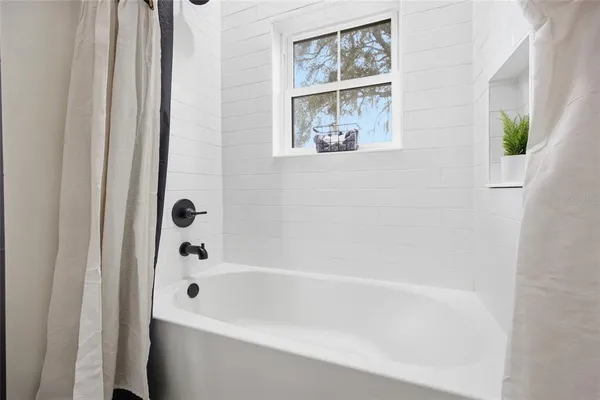 a house view with swimming pool in front of it