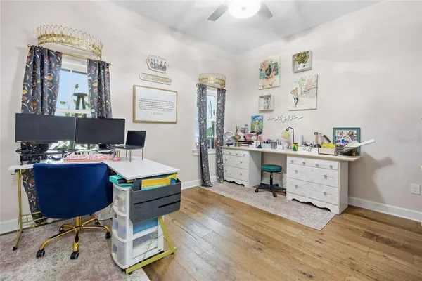 a view of a house with a yard and large trees
