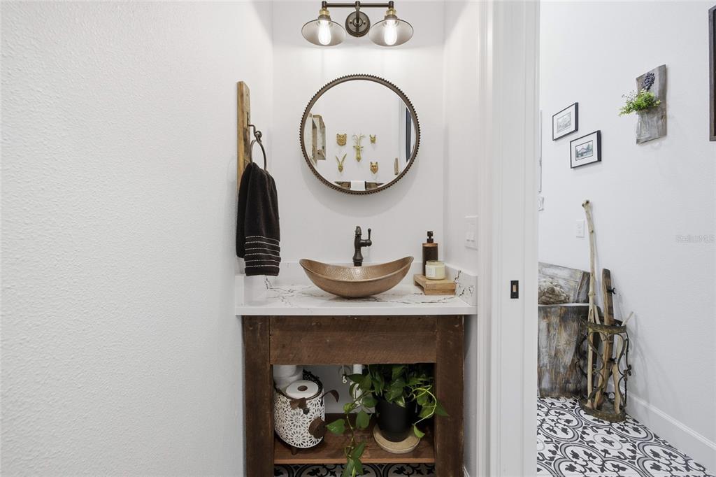 12052 Southeast 101st Court Road Belleview, FL 34420 - Photo 36 of 74 a bathroom with a mirror and a wooden floor