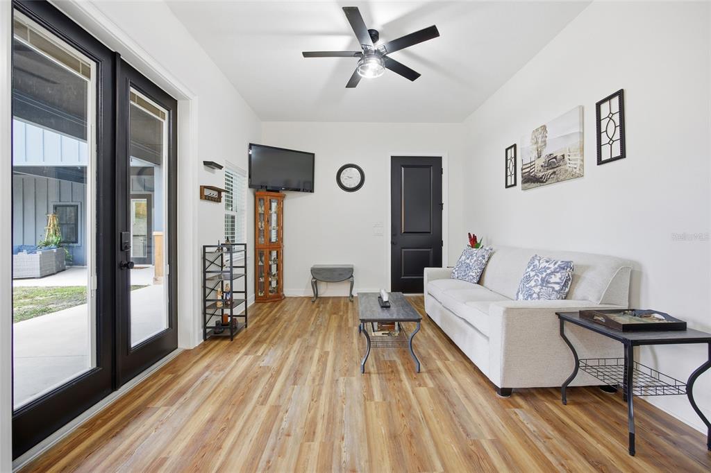 12052 Southeast 101st Court Road Belleview, FL 34420 - Photo 45 of 74 a living room with furniture and a wooden floor