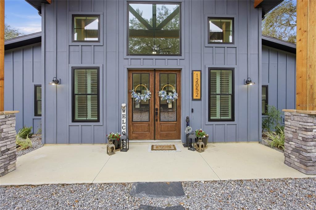 12052 Southeast 101st Court Road Belleview, FL 34420 - Photo 5 of 74 a view of a brick house with potted plants