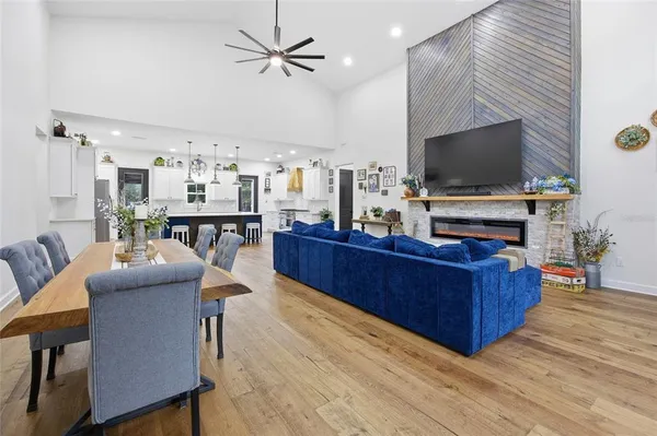 a large kitchen with kitchen island a sink stainless steel appliances and a chandelier