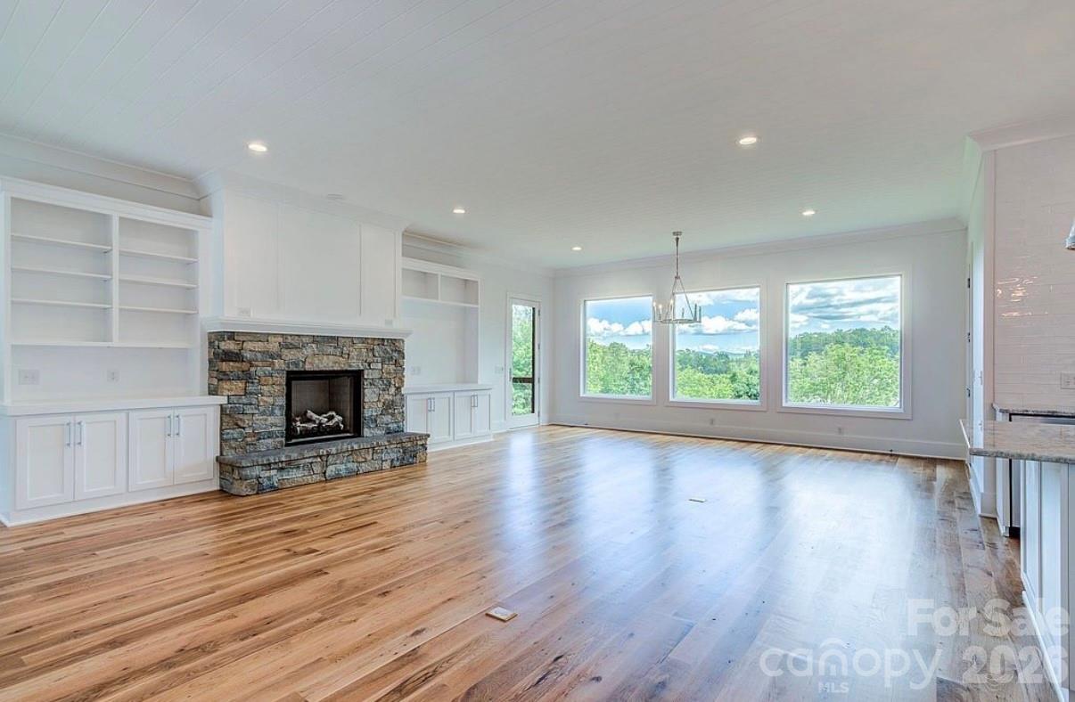 3434 Old Jonas Ridge Road Newland, NC 28657 - Photo 19 of 46 a view of empty room with wooden floor and fireplace