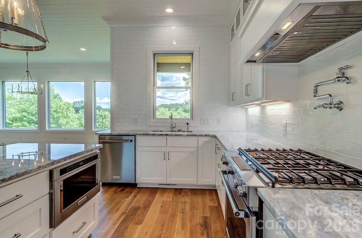 3434 Old Jonas Ridge Road Newland, NC 28657 - Photo 22 of 46 a kitchen with sink a stove and a window