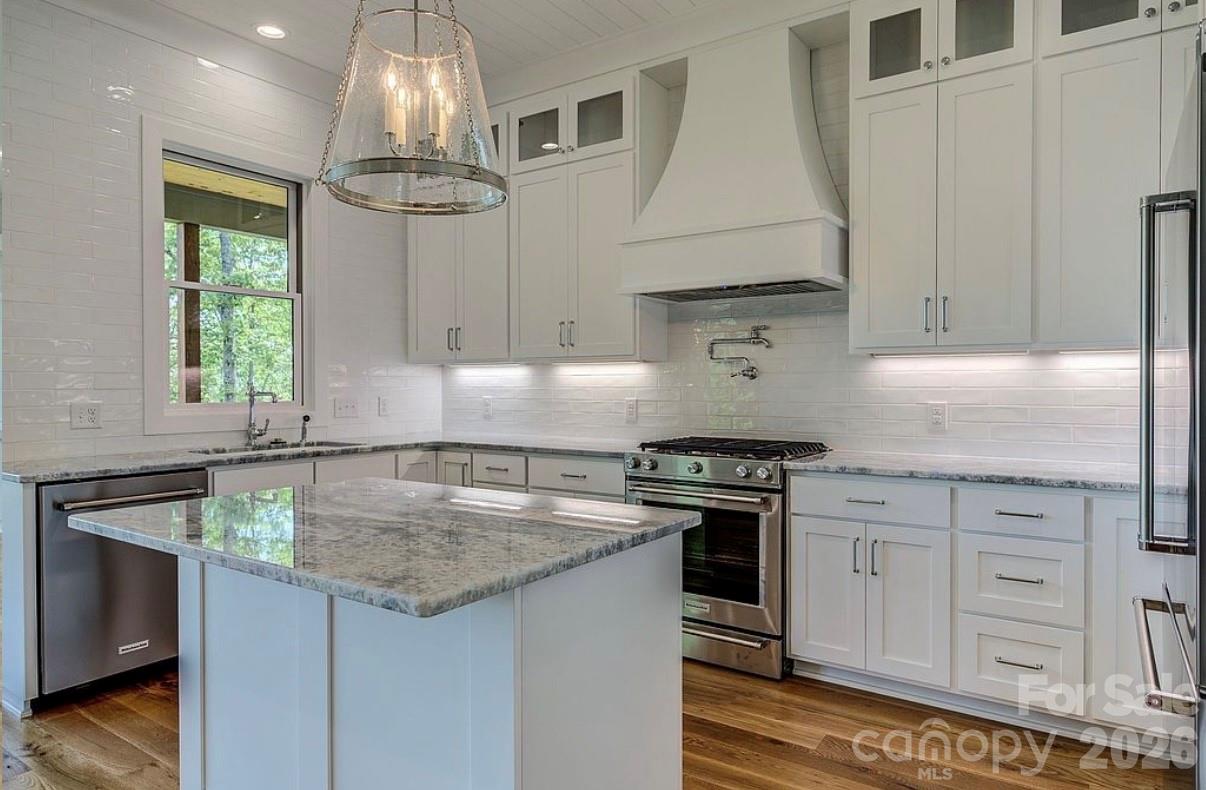 3434 Old Jonas Ridge Road Newland, NC 28657 - Photo 24 of 46 a kitchen with stainless steel appliances granite countertop a sink stove and cabinets