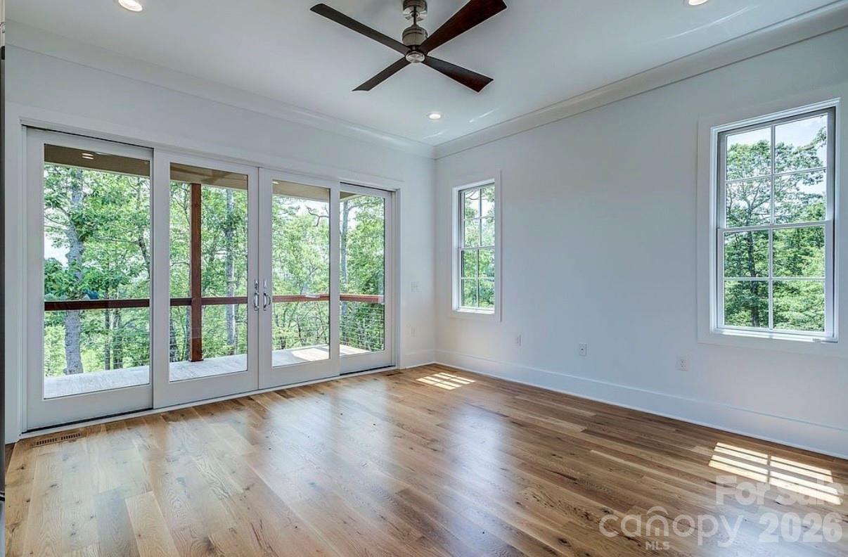 3434 Old Jonas Ridge Road Newland, NC 28657 - Photo 25 of 46 a view of an empty room with wooden floor and a window