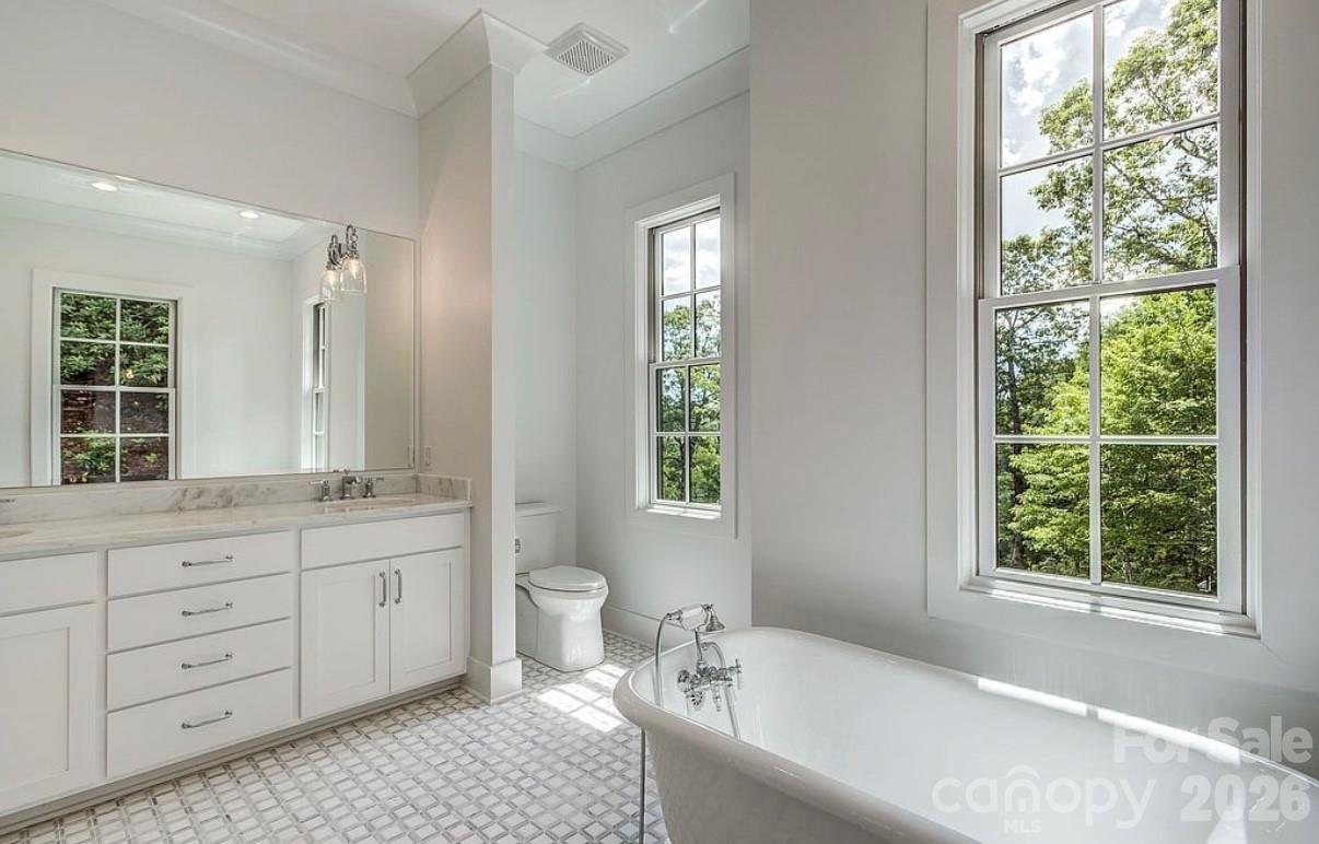 3434 Old Jonas Ridge Road Newland, NC 28657 - Photo 28 of 46 a bathroom with a granite countertop toilet a sink and a bathtub