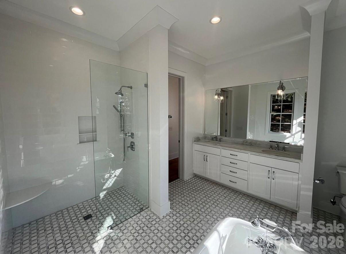 3434 Old Jonas Ridge Road Newland, NC 28657 - Photo 29 of 46 a spacious bathroom with a double vanity sink a toilet and a shower