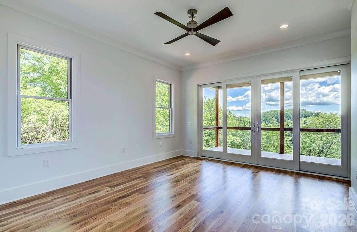 3434 Old Jonas Ridge Road Newland, NC 28657 - Photo 30 of 46 a view of an empty room with wooden floor and a window