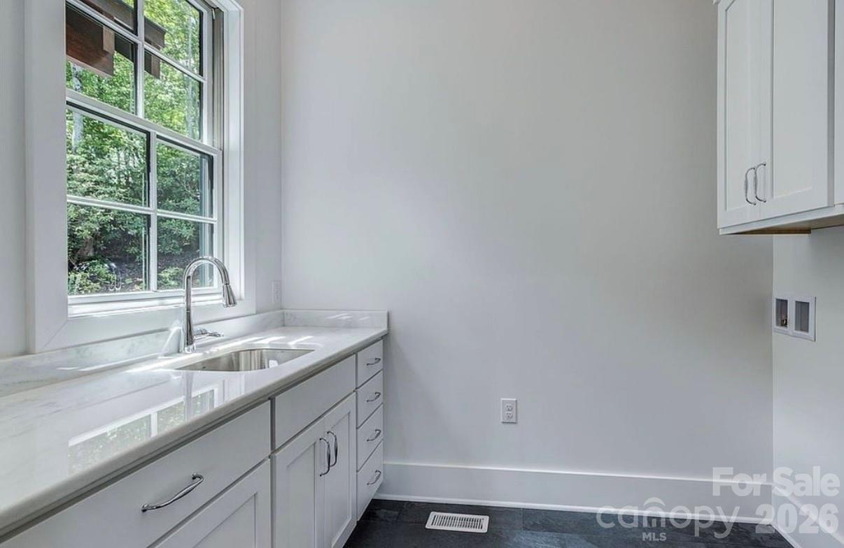 3434 Old Jonas Ridge Road Newland, NC 28657 - Photo 32 of 46 a bathroom with a granite countertop sink and window