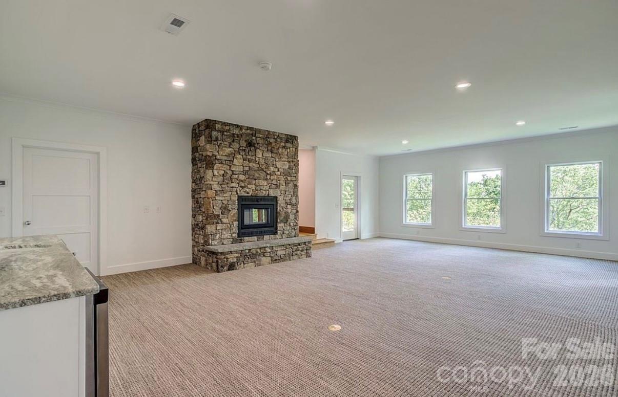 3434 Old Jonas Ridge Road Newland, NC 28657 - Photo 35 of 46 a view of an empty room with a fireplace and a window
