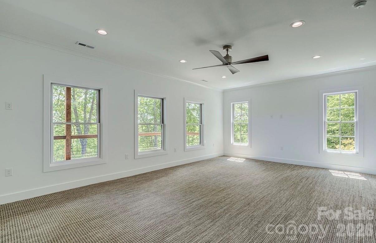 3434 Old Jonas Ridge Road Newland, NC 28657 - Photo 37 of 46 a view of an empty room with a window and wooden floor