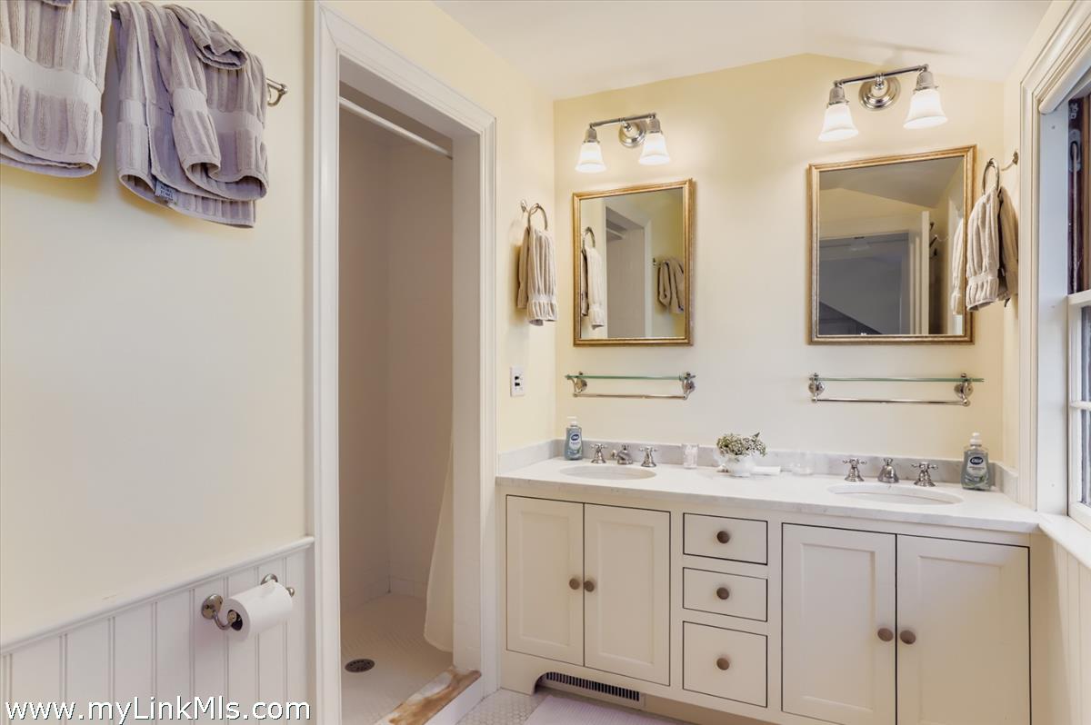 27 Spring Street Vineyard Haven, MA 02568 - Photo 43 of 58 a bathroom with a double vanity sink and mirror