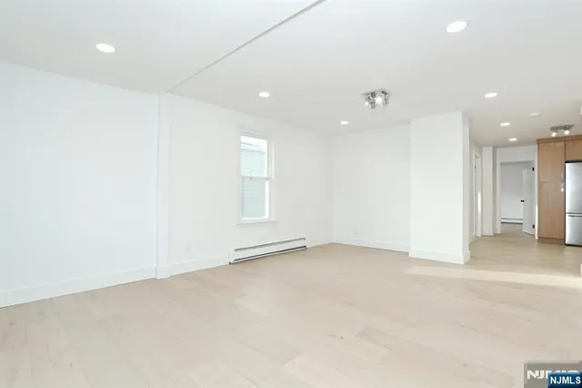 an empty room with window and pillar in it