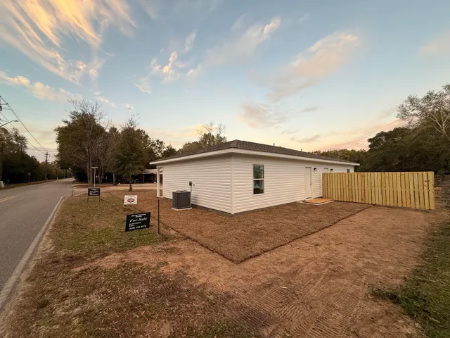 a view of a backyard with a garden and entertaining space