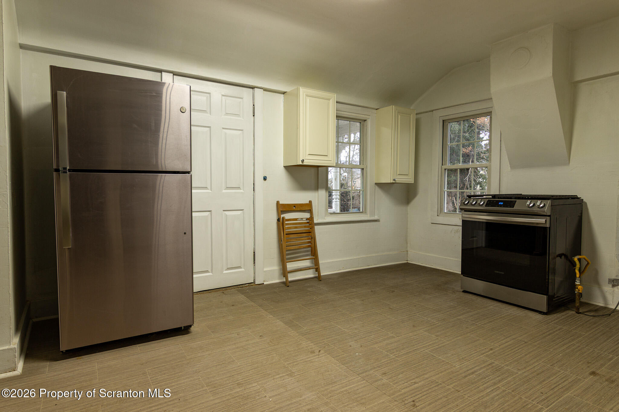 214 William Street Scranton, PA 18508 - Photo 6 of 33 a kitchen with a refrigerator and a stove top oven