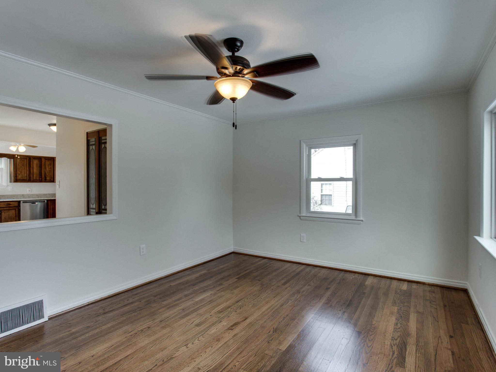 11606 Joseph Mill Road Silver Spring, MD 20906 - Photo 3 of 30 a view of a ceiling fan with wooden floor and a window