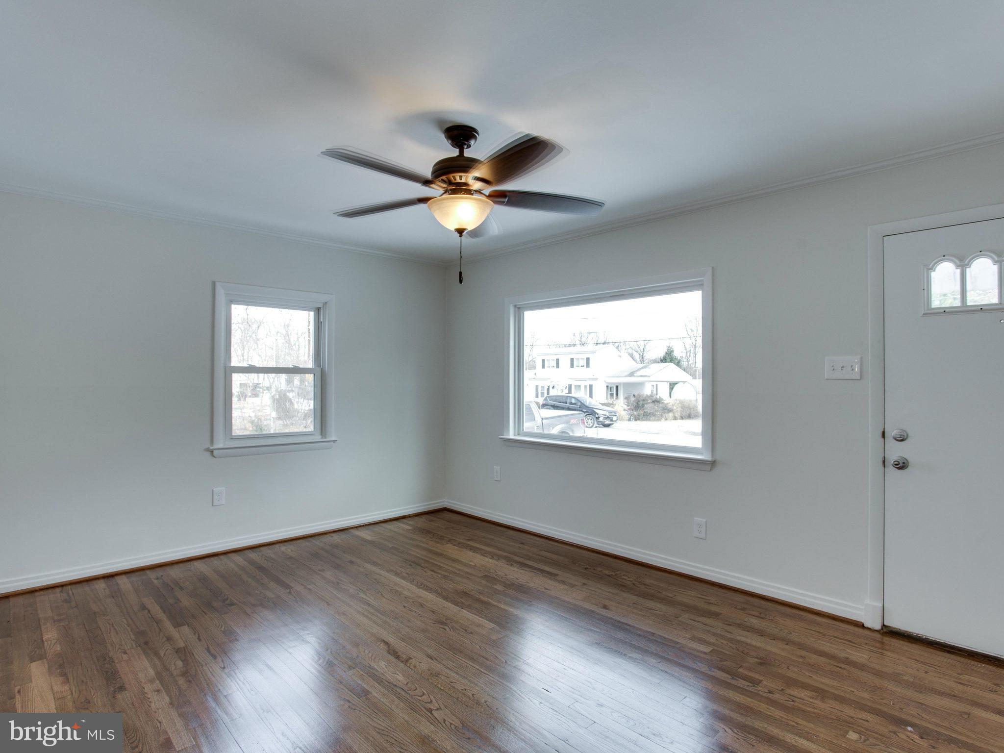 11606 Joseph Mill Road Silver Spring, MD 20906 - Photo 5 of 30 a view of an empty room with wooden floor and a window