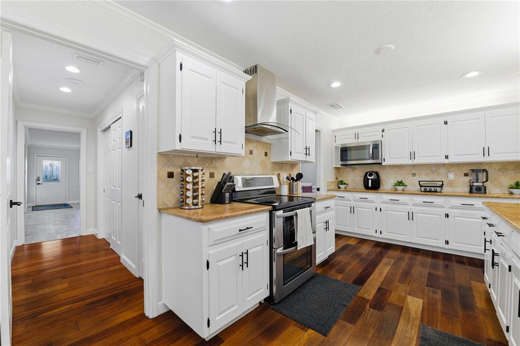 15509 Casey Rd Extension Tampa, FL 33624 - Photo 11 of 65 a kitchen with stainless steel appliances sink stove top oven and cabinets