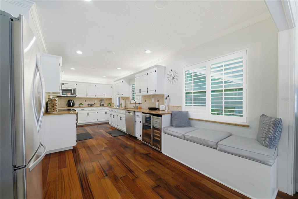 15509 Casey Rd Extension Tampa, FL 33624 - Photo 13 of 65 a kitchen with a refrigerator and white cabinets