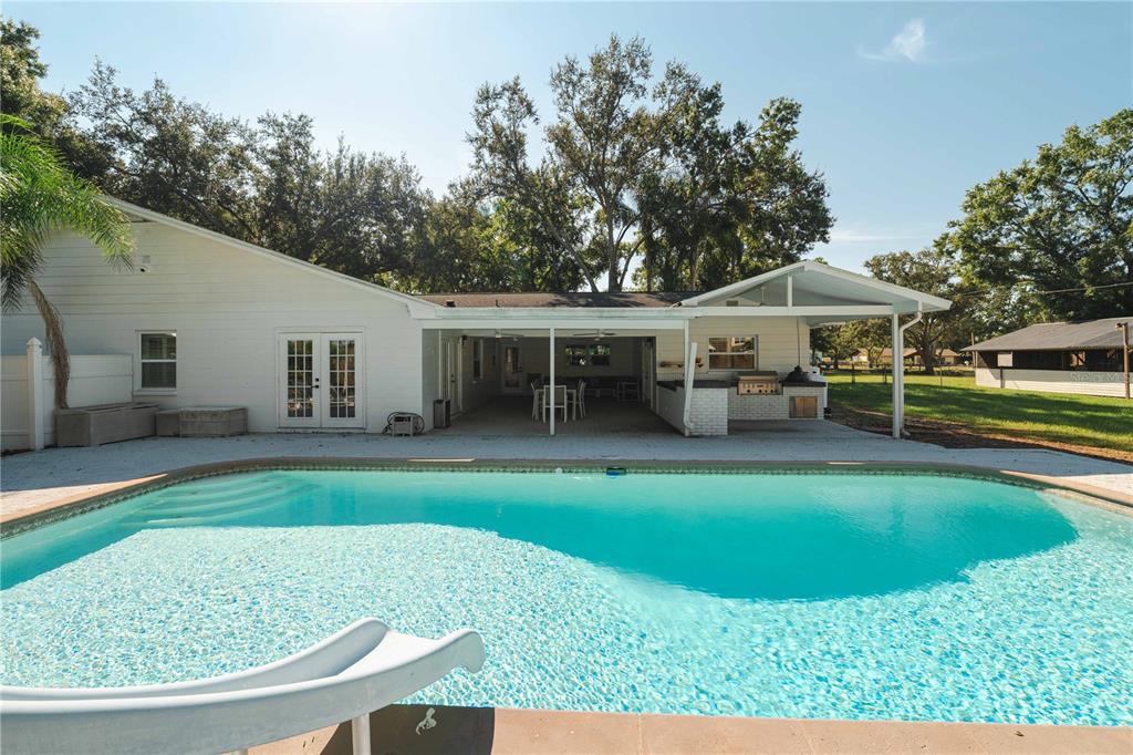 15509 Casey Rd Extension Tampa, FL 33624 - Photo 2 of 65 a view of a house with backyard porch and sitting area