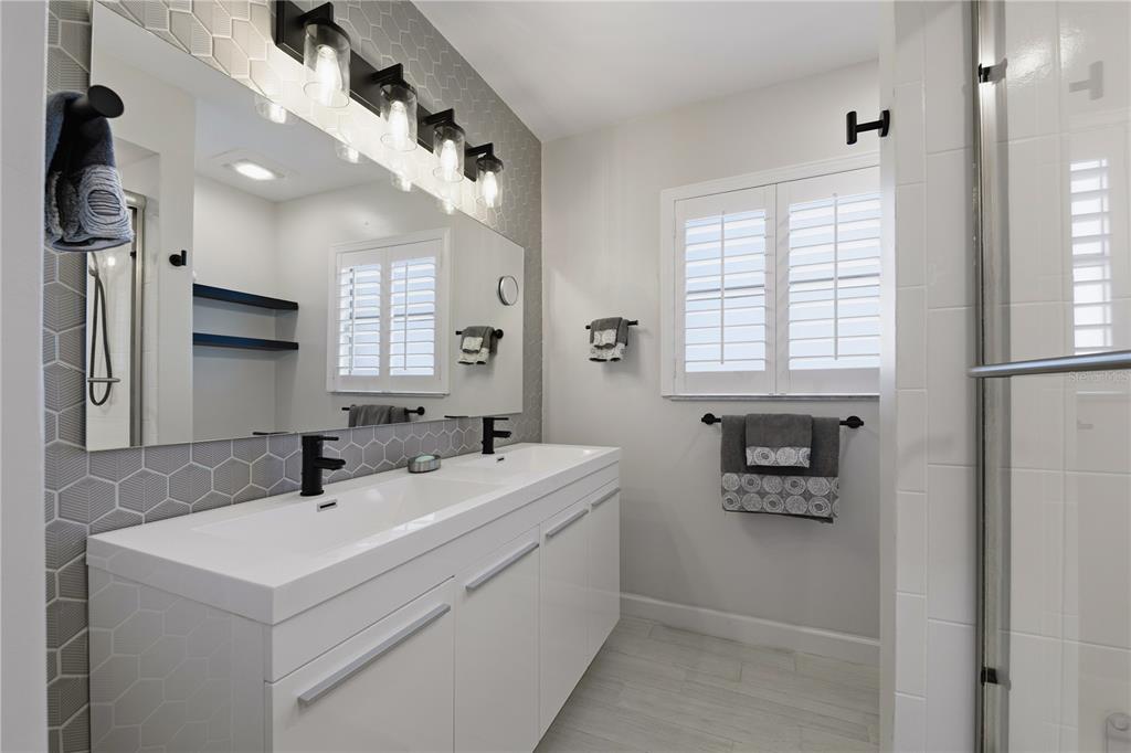 15509 Casey Rd Extension Tampa, FL 33624 - Photo 26 of 65 a bathroom with a sink a toilet and a mirror