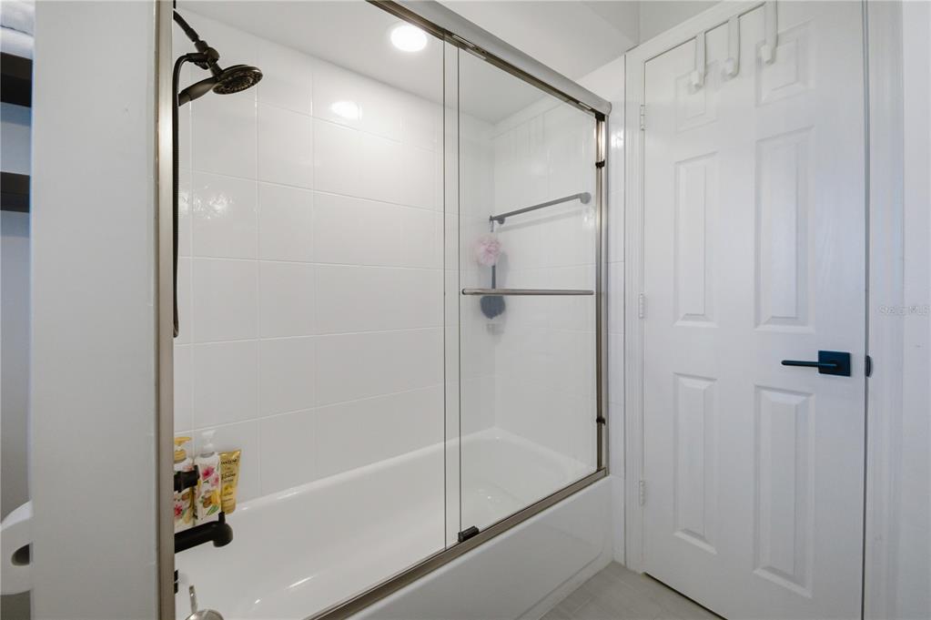 15509 Casey Rd Extension Tampa, FL 33624 - Photo 27 of 65 a bathroom with a shower and a glass door