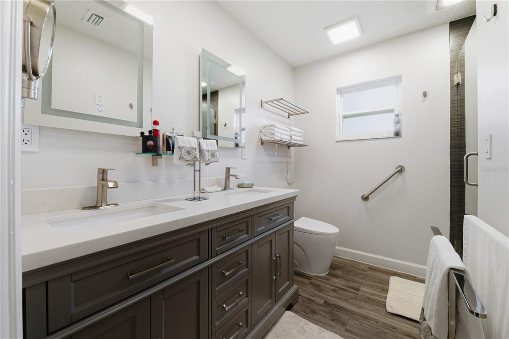 15509 Casey Rd Extension Tampa, FL 33624 - Photo 35 of 65 a bathroom with a granite countertop sink toilet and mirror