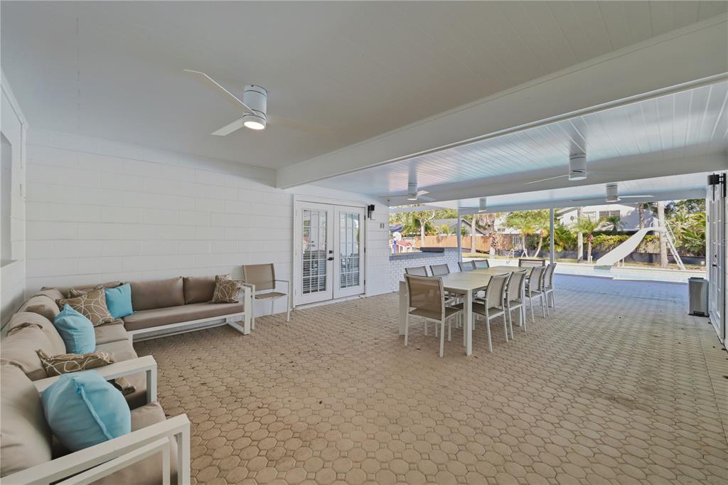 15509 Casey Rd Extension Tampa, FL 33624 - Photo 38 of 65 a dining room with furniture and a floor to ceiling window