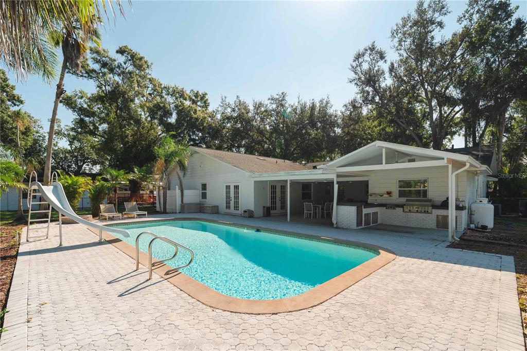 15509 Casey Rd Extension Tampa, FL 33624 - Photo 41 of 65 a view of a house with swimming pool and sitting area