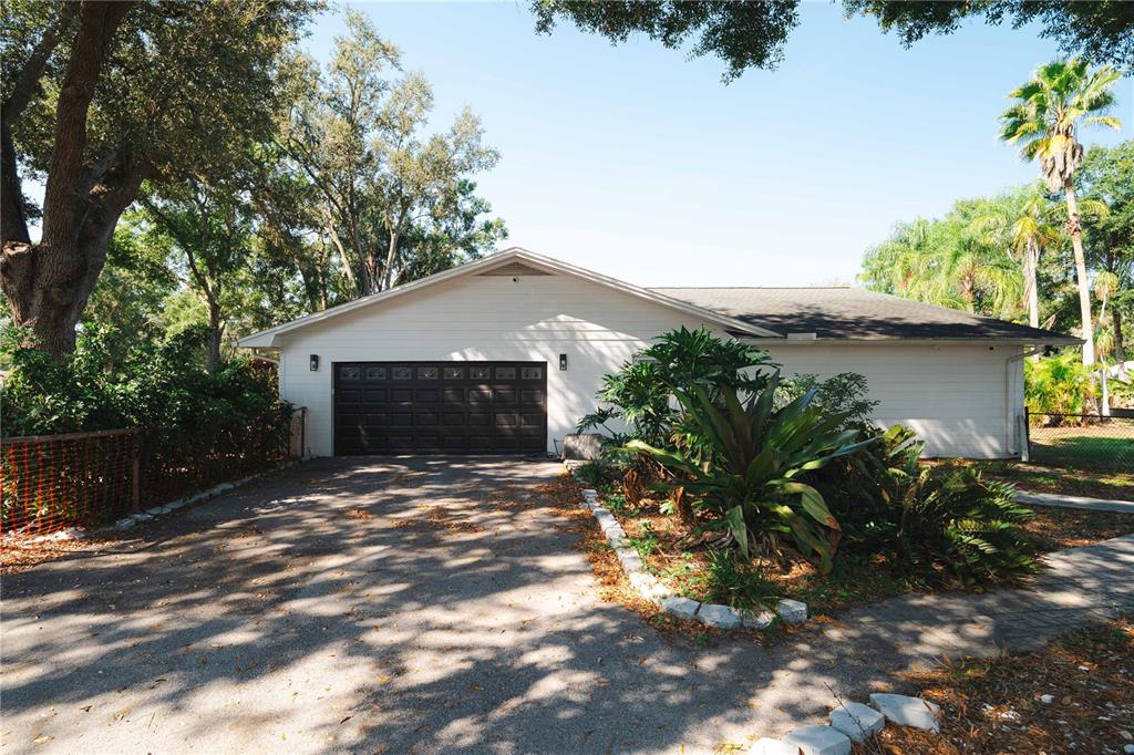 15509 Casey Rd Extension Tampa, FL 33624 - Photo 51 of 65 a front view of a house with a yard and garage