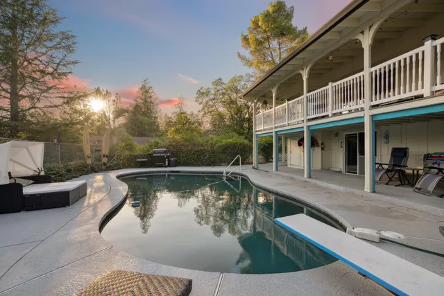 a view of a swimming pool with sitting area