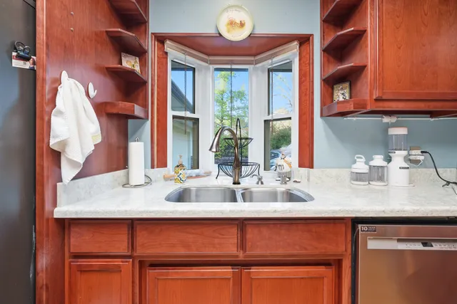 a kitchen with a sink and a wooden floor