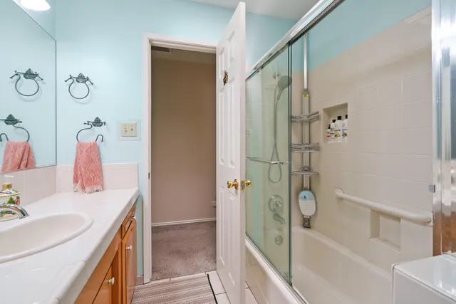 a bathroom with a sink and a mirror with bathtub