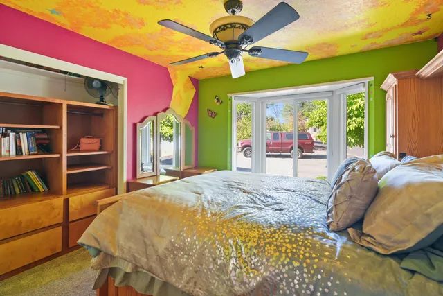 a bed sitting in a bedroom next to a window