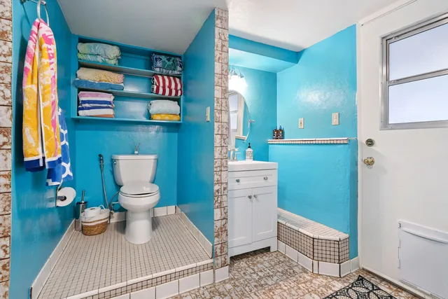 a bathroom with a toilet and a sink