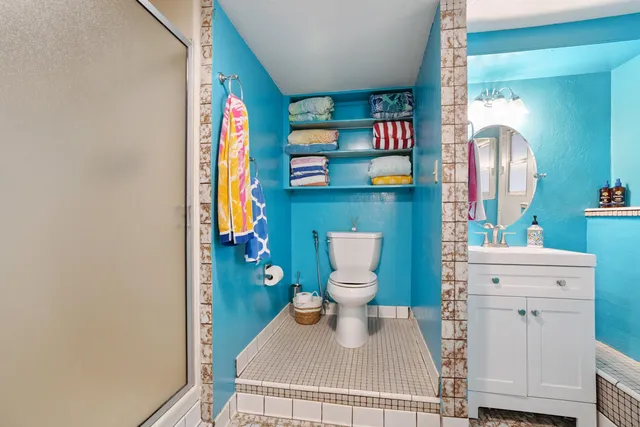 a bathroom with a toilet sink and mirror