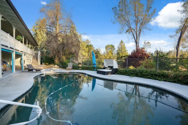 a view of a swimming pool with a patio