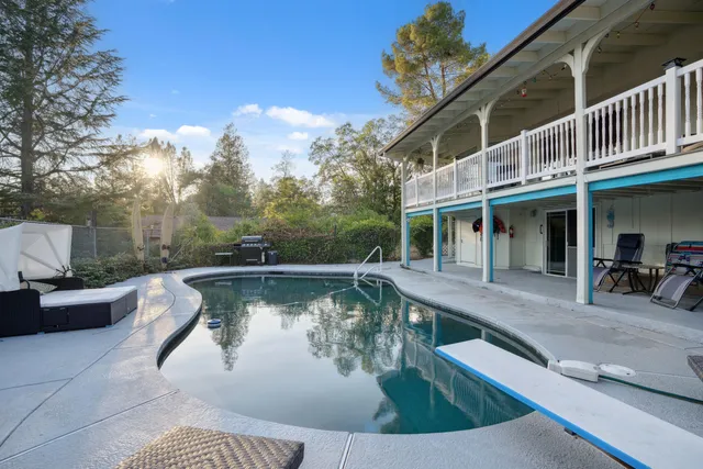 a view of a swimming pool with sitting area