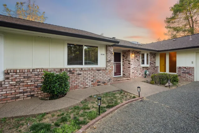 a front view of a house with garden