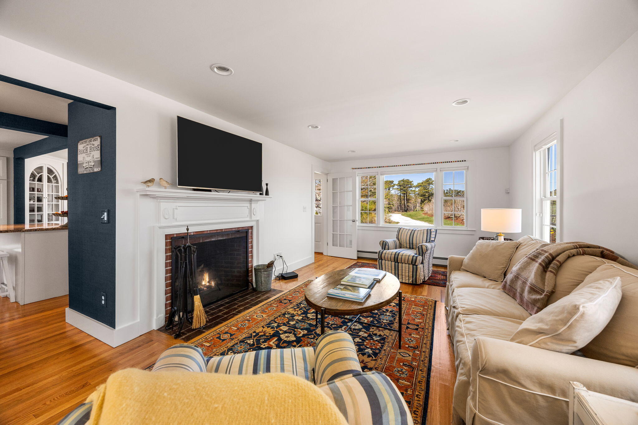 58 Stepping Stones Road Chatham, MA 02633 - Photo 14 of 52 a living room with furniture a flat screen tv and a fireplace