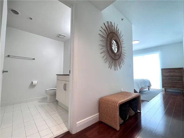 a bathroom with a granite countertop toilet and sink