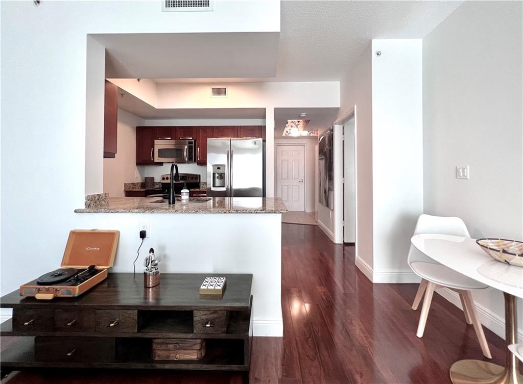 7275 Southwest 90th Way, Unit 504 Miami, FL 33156 - Photo 19 of 24 a living room with furniture and a wooden floor