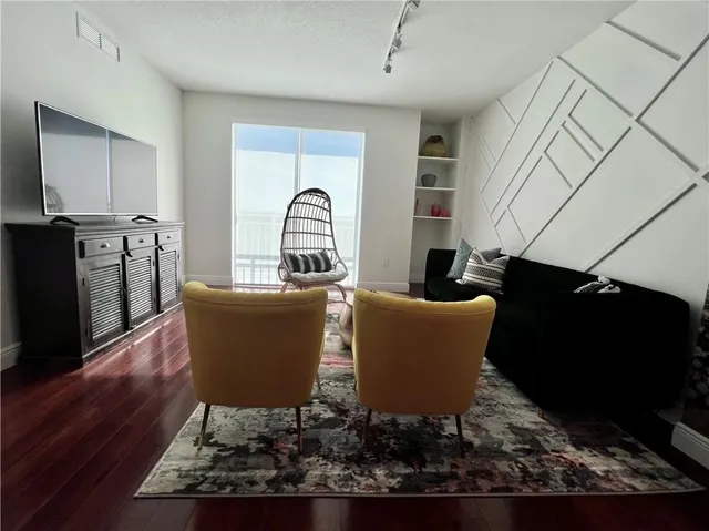a living room with furniture and a lamp