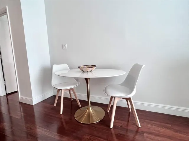a living room with furniture a window and a potted plant