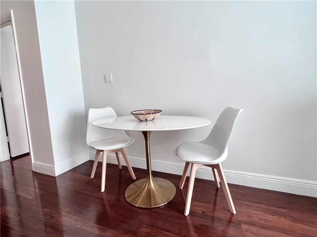 7275 Southwest 90th Way, Unit 504 Miami, FL 33156 - Photo 8 of 24 a view of a dining room with furniture and wooden floor