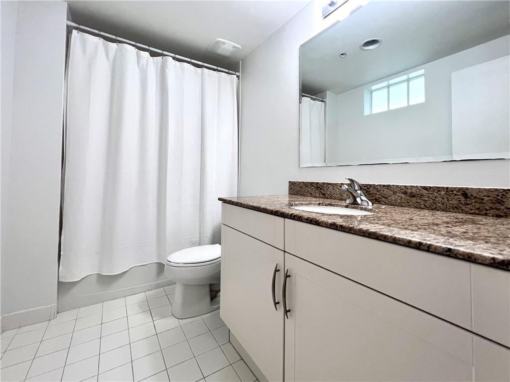 7275 Southwest 90th Way, Unit 504 Miami, FL 33156 - Photo 10 of 24 a bathroom with a granite countertop sink and a toilet
