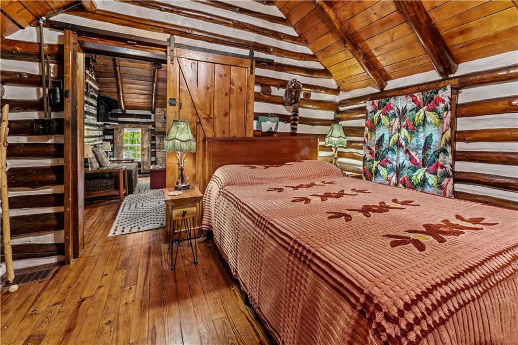 124 New Beaver Creek Road Markleysburg, PA 15459 - Photo 25 of 31 a bed sitting in a bedroom next to a window