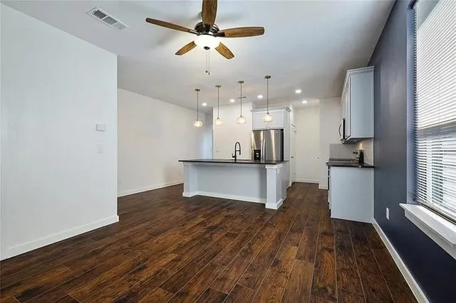 a view of kitchen with refrigerator microwave and wooden floor